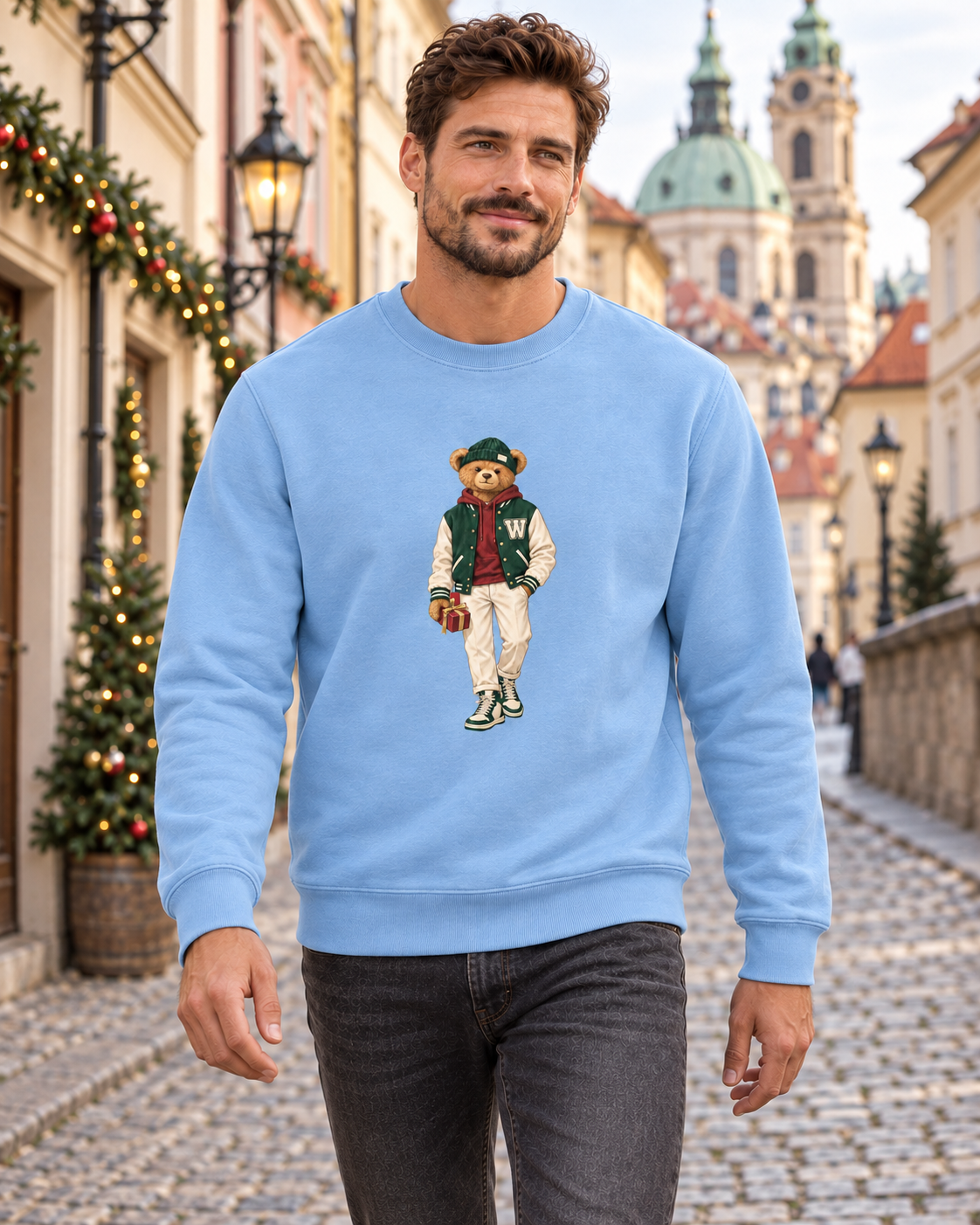 Man in a light blue Winter Club bear crewneck sweatshirt walking through Prague’s Lesser Town.