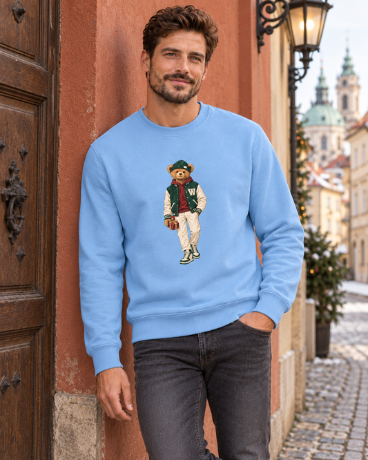 Man in a light blue Winter Club bear crewneck sweatshirt by a historic building in Prague.